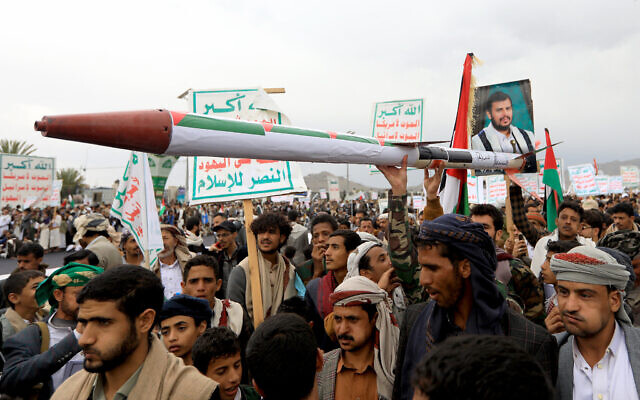 Yemeni demonstrators carry a mock missile during a pro-Palestinian and anti-Israel rally in the Houthi-held capital Sanaa on April 26, 2024. (Mohammed Huwais/AFP)