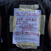 A US protester wears Columbia University's disciplinary notice covered over by support for Palestinians in Gaza at Columbia University on April 29, 2024 in New York City. (Alex Kent / GETTY IMAGES NORTH AMERICA / Getty Images via AFP)