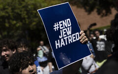 A demonstrator holds a poster reading "End Jew Hatred" on the campus of the University of California Los Angeles (UCLA), in Los Angeles on April 28, 2024. (Etienne Laurent/AFP)