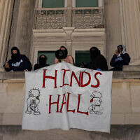 Demonstrators from the pro-Palestinian encampment on Columbia's campus show a banner as they barricade themselves inside Hamilton Hall, an academic building which has been occupied in past student movements, and name it after a Palestinian child allegedly killed in Gaza, April 30, 2024 in New York City. (Alex Kent/Getty Images North America/Getty Images via AFP)