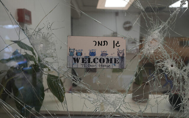 A bullet-shuttered window of the entrance to a kindergarten is seen in Kibbutz Be'eri on Oct. 11, 2023 (AP Photo/Baz Ratner)