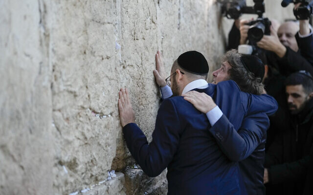 Argentine President Javier Milei, right, hugs Argentine Sephardic Orthodox rabbi Shimon Axel Wahnish at the Western Wall, in Jerusalem's Old City, Tuesday, February 6, 2024. (AP Photo/Leo Correa)