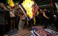 Iranian protesters burn representations of the US and Israeli flags during a gathering to condemn killing members of the Iranian Revolutionary Guards in Syria, at the Felestin (Palestine) Sq. in downtown Tehran, April 1, 2024. (AP Photo/Vahid Salemi)