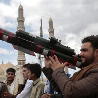 A Houthi supporter holds a mock missile during a protest marking Jerusalem Day in support of Palestinians in the Gaza Strip, in Sanaa, Yemen, April 5, 2024. (AP Photo/Osamah Abdulrahman)