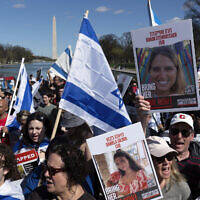 People holding photographs of Israeli family members abducted by Hamas on October 7, 2023, rally at the Lincoln Memorial in Washington, Sunday, April 7, 2024. (AP/Jose Luis Magana)