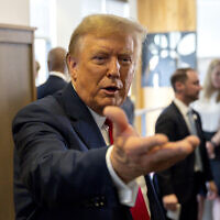 Presumptive Republican nominee, former US President Donald Trump gestures as he visits a Chick-fil-A eatery in Atlanta, Georgia, April 10, 2024. (AP Photo/Jason Allen)