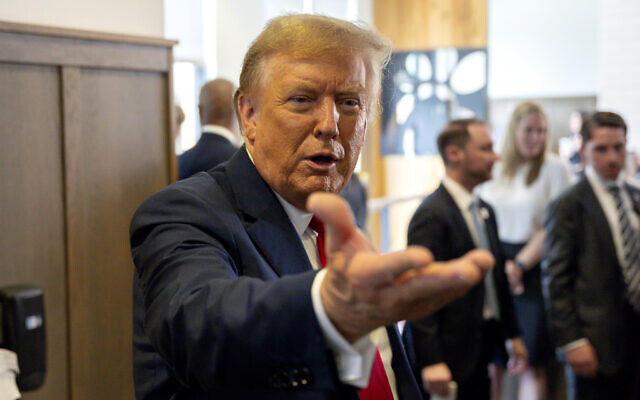 Presumptive Republican nominee, former US President Donald Trump gestures as he visits a Chick-fil-A eatery in Atlanta, Georgia, April 10, 2024. (AP Photo/Jason Allen)