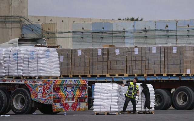 Trucks carrying humanitarian aid for the Gaza Strip pass through the inspection area at the Kerem Shalom Crossing in southern Israel, Thursday, March 14, 2024.  (AP Photo/Ohad Zwigenberg, File)