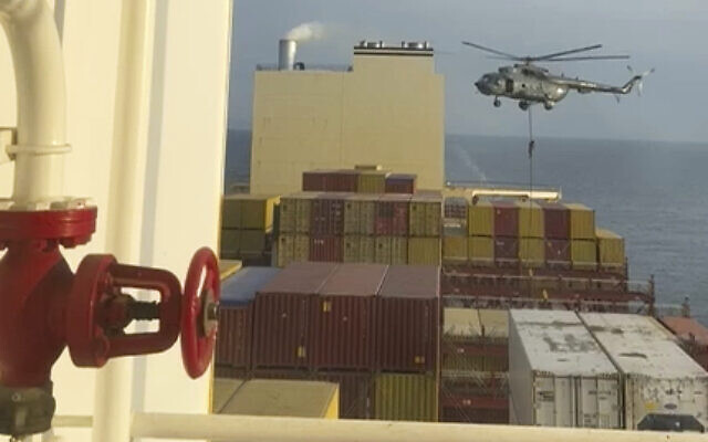 This image made from a video provided to The Associated Press by a Mideast defense official shows a helicopter raid targeting a vessel near the Strait of Hormuz on April 13, 2024. (AP Photo)