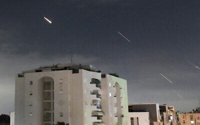 Israeli air defense systems intercept missiles fired from Iran, in central Israel, April 14, 2024. (AP/Tomer Neuberg)
