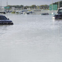 Vehicles sit abandoned in floodwater covering a major road in Dubai, United Arab Emirates, April 17, 2024. (Jon Gambrell/AP)