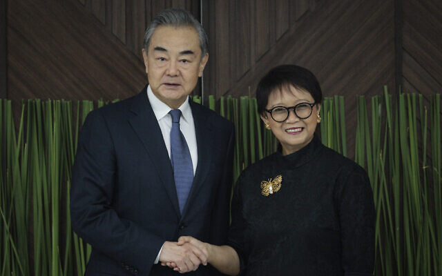 Indonesian Foreign Minister Retno Marsudi, right, shakes hands with Chinese Foreign Minister Wang Yi during their bilateral meeting in Jakarta, Indonesia, April 18, 2024. (Yasuyoshi Chiba/Pool Photo via AP)