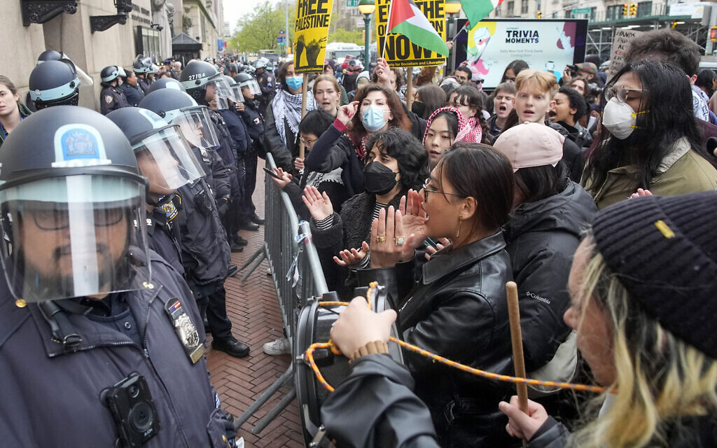 New York Police Department officers in riot gear stand guard as pro-Palestinian, anti-Israel demonstrators chant slogans outside the Columbia University campus, April 18, 2024, in New York City. (AP Photo/Mary Altaffer)