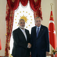 Turkey's President Recep Tayyip Erdogan, right, and Hamas leader Ismail Haniyeh, shake hands during their meeting in Istanbul, Turkey, April 20, 2024. (Turkish Presidency via AP)