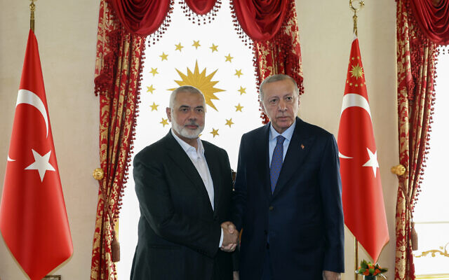 Turkey's President Recep Tayyip Erdogan, right, and Hamas leader Ismail Haniyeh, shake hands during their meeting in Istanbul, Turkey, April 20, 2024. (Turkish Presidency via AP)