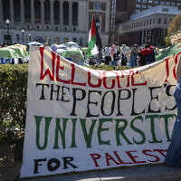 A sign declaring Columbia University to be "the people's university of Palestine" is displayed in front of tents erected at an anti-Israel protest encampment set up by pro-Palestinian demonstrators, on the Ivy League school's campus in New York on April 22, 2024. (AP Photo/Stefan Jeremiah)