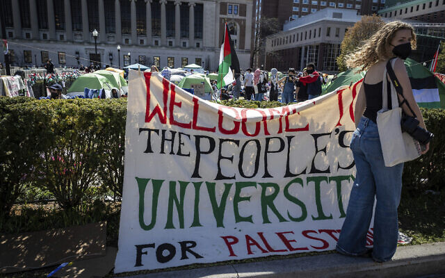 A sign declaring Columbia University to be "the people's university of Palestine" is displayed in front of tents erected at an anti-Israel protest encampment set up by pro-Palestinian demonstrators, on the Ivy League school's campus in New York on April 22, 2024. (AP Photo/Stefan Jeremiah)