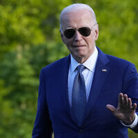 US President Joe Biden waves as he walks across the South Lawn of the White House in Washington, April 23, 2024. (AP Photo/Susan Walsh)
