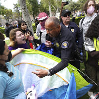 University of Southern California protesters fight with University Public Safety officers as they try to remove tents at the campus' Alumni Park during a pro-Palestinian occupation in Los Angeles, on April 24, 2024. (Richard Vogel/AP)
