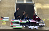 Peo-Palestinian, anti-Israel students blocking the Sciences Po University flash the V sign, April 26, 2024 in Paris, France. (AP Photo/Jeffrey Schaeffer)