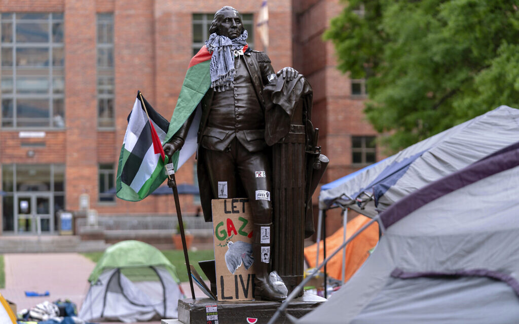 A statue of George Washington draped in a Palestinian flag and a keffiyeh is seen at George Washington University, April 26, 2024, in Washington. (AP Photo/Jose Luis Magana)