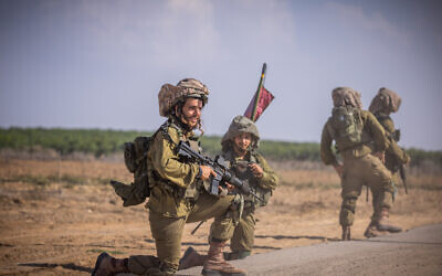 Israeli soldiers from the Netzah Yehuda Battalion patrol near the Israeli-Gaza border, October 20, 2023. (Yonatan Sindel/Flash90)
