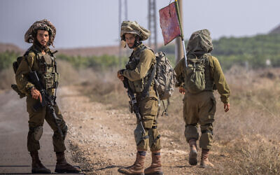 Illustrative: Soldiers from the IDF's Netzah Yehuda Battalion patrol near the Israeli-Gaza border, October 20, 2023. (Yonatan Sindel/Flash90)