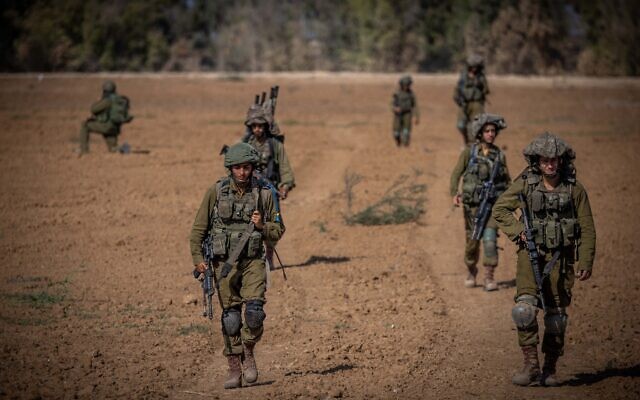 File - Israeli soldiers from the Netzah Yehuda Battalion patrol near the Israeli-Gaza border, October 20, 2023. (Yonatan Sindel/ Flash90)