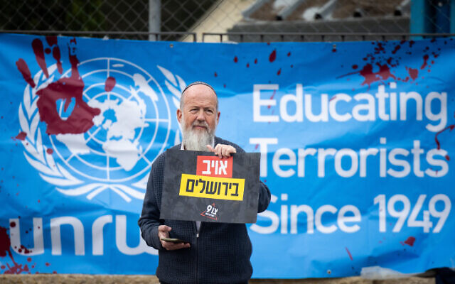 Activists protest against United Nations Relief and Works Agency for Palestine Refugees (UNRWA) outside their offices in Jerusalem, March 27, 2024. (Yonatan Sindel/Flash90)