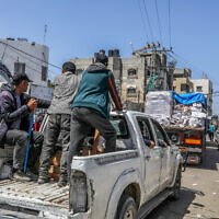 Armed and masked Palestinians seen on trucks loaded with international humanitarian aid entering Gaza through Israel's Kerem Shalom crossing, into southern Gaza on April 3, 2024. (Abed Rahim Khatib/Flash90)