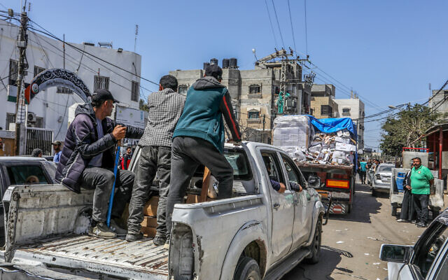 Armed and masked Palestinians seen on trucks loaded with International humanitarian aid entering Gaza through Israel's Kerem Shalom crossing, into the southern Gaza Strip on April 3, 2024 (Photo by Abed Rahim Khatib/Flash90)