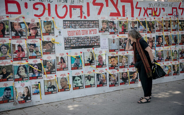 People visit Hostages Square in Tel Aviv on April 7, 2024, six months after Hamas's October 7 massacre, which saw terrorists kill some 1,200 people and seize 253 hostages - 129 of whom are still held hostage in Gaza. (Miriam Alster/FLASH90)
