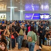 Passengers at the departure hall in the Ben Gurion Airport near Tel Aviv on April 14, 2024. (Avshalom Sassoni/Flash90)