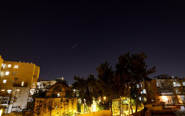An anti-missile system fires interception missiles at drones and missiles fired from Iran, as it seen over Jerusalem, on April 14, 2024. (Chaim Goldberg/Flash90)