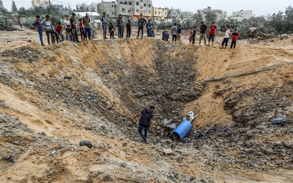 Palestinians at the site of an Israeli air strike in Rafah, in the southern Gaza Strip, on April 18, 2024. (Abed Rahim Khatib/Flash90)