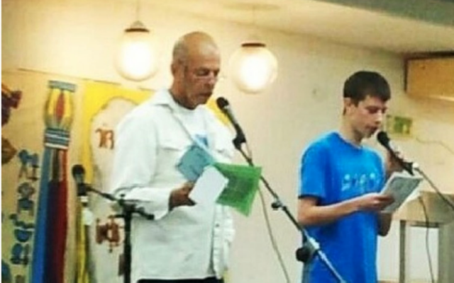 Hostage Chaim Peri (left) and his grandson, Mai Albini, at an earlier Passover in Kibbutz Nir Oz. (Screenshot/Courtesy)