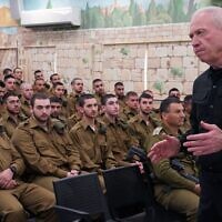 Defense Minister Yoav Gallant speaks to soldiers drafting into the IDF's Armored and Combat Engineering Corps at the Tel Hashomer military base, central Israel, April 8, 2024. (Ariel Hermoni/Defense Ministry)