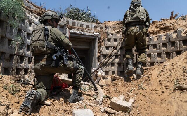 IDF troops operate at the entrance to a tunnel in the central Gaza Strip, in a handout image published April 18, 2024. (Israel Defense Forces)