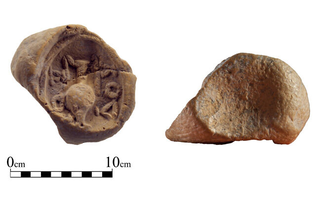 Clay token found in the sifting of dirt from the Temple Mount, bearing a Greek inscription and impression of a wine jug. (Zachi Dvira/Temple Mount Shifting Project)