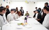 Ukrainian President Volodymyr Zelensky sits with students from the Simcha School in Kyiv for a model Passover seder, April 18, 2024. (Courtesy FJCU via JTA)