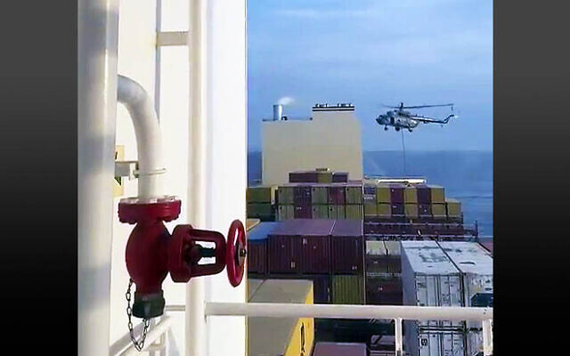 This image grab taken from a UGC video posted on social media on April 13, 2024, shows Iran's Revolutionary Guards rappelling down onto a container ship, MSC Aries, near the Strait of Hormuz. (Video screenshot)