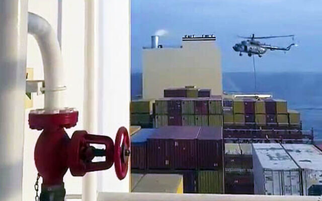 This image grab taken from a UGC video posted on social media on April 13, 2024 shows Iran's Revolutionary Guards rappelling down onto a container ship, MSC Aries, near the Strait of Hormuz (Video screenshot)
