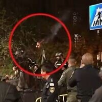 A screen grab provided by police from a video apparently showing a torch thrown by a protester toward a mounted officer during a demonstration in Jerusalem on April 3, 2024 (Israel Police)
