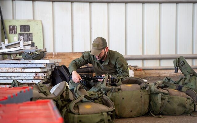 An IDF reservist prepares equipment ahead of a drill, in a handout image released on April 24, 2024. (Israel Defense Forces)