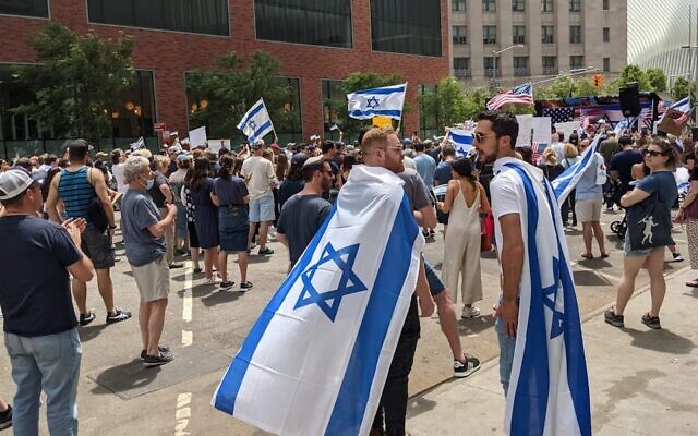 Illustrative: Two men wearing Israeli flags in New York City on May 23, 2021. (Ben Sales via JTA)