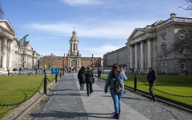 People walk around the grounds of Trinity College Dublin on March 12, 2020. (Paul Faith / AFP)