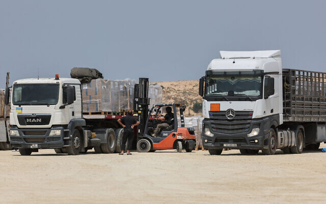 Workers unload a truck in Beit Hanoun in the northern Gaza Strip of humanitarian aid delivered from Jordan to the coastal territory through the Erez border crossing with Israel, on May 1, 2024. (Jack Guez/AFP)