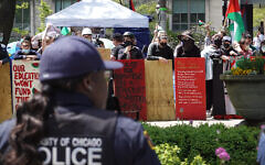 Campus police stand between demonstrators at a pro-Palestinian, anti-Israel encampment on the campus of the University of Chicago and counter demonstrators after a brief skirmish between the groups on May 3, 2024 in Chicago, Illinois. (Scott Olson/Getty Images/AFP)