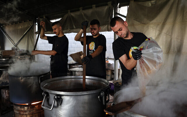 Illustrative - Local volunteers of the World Central Kitchen cook meals to be distributed to displaced Palestinians in Rafah in the southern Gaza Strip on May 3, 2024. (Photo by AFP)