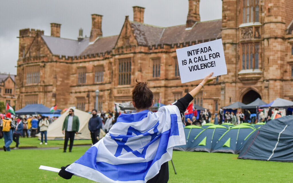 A member of the Australian Jewish community holds up a sign against anti-Israel sentiment seen at a pro-Palestinian protests, University of Sydney, May 3, 2024. (Ayush Kumar/AFP)